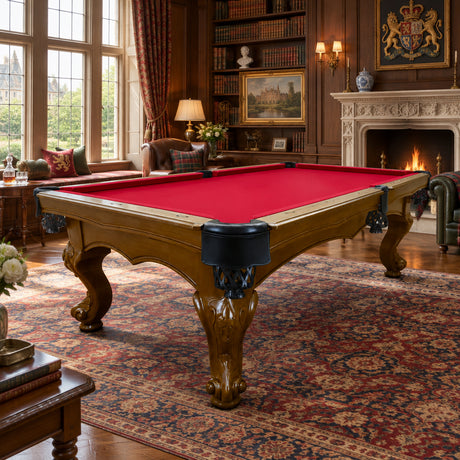 An ornate pool table with a bright red felt playing surface and a carved dark brown wooden frame with black pockets, shown on a plain white background.